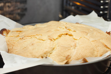 Cooking apple pie. The finished cake is taken out of the oven.