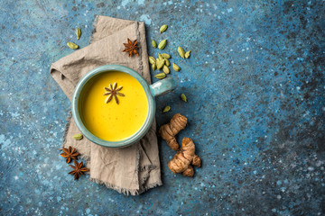 Fototapeta na wymiar Healthy drink of golden turmeric milk with spices