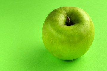 Green apple on a green background