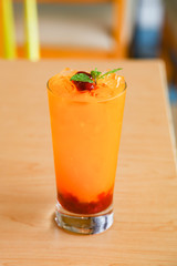 Fresh orange juice soda with strawberry syrup