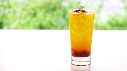 Fresh orange juice soda with strawberry syrup