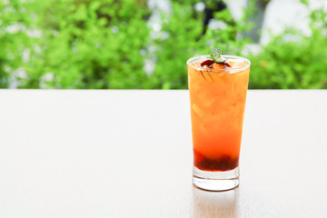 Fresh orange juice soda with strawberry syrup