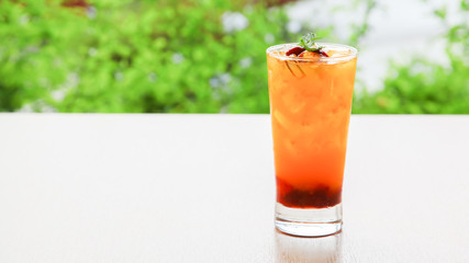 Fresh orange juice soda with strawberry syrup