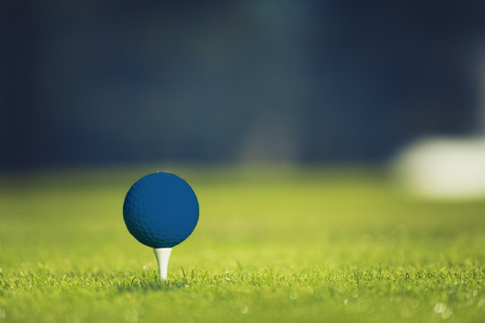 Close up of blue golf ball on tee. Concept of the fresh start. Horizontal
