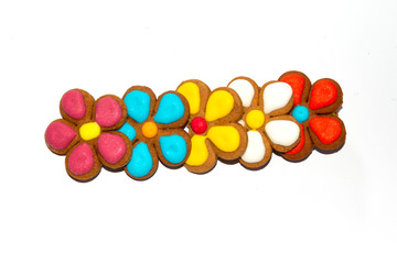 Gingerbread with glaze in the form of a flower with petals isolated on a white background