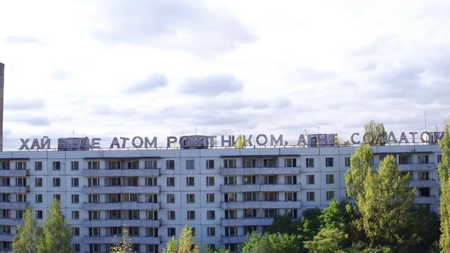 Aerial view of house labeled "&rsquo;ай буде атом робiтником, а не солдатом" in Pripyat town. Aerial shooting abandoned architecture of ghost city
