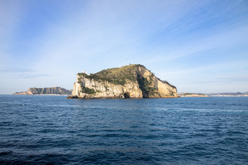 Fototapeta na wymiar Campi Flegrei, Naples, Campania, Italy: the lighthouse of Cape Miseno seen from the sea. Capo Miseno is the headland on the Bay of Pozzuoli and the Gulf of Naples