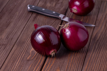 Red onion on a table with a knife