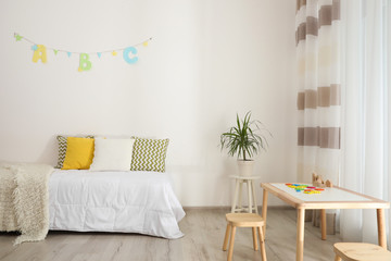 Modern child room interior with comfortable bed