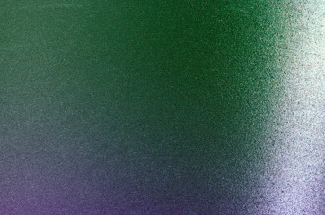 Abstract metal disk background texture shimmers in blue - green color with gradient.