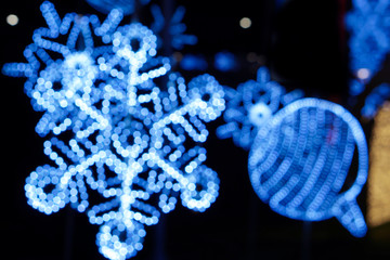 Blurred and bokeh decorated led of Christmas blue lighting in snowflake shape on night time and...