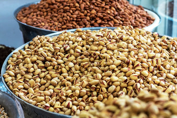 Heap of delicious fresh nuts (pistachios and almonds) in the eastern bazaar.