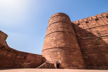 Agra, Uttar Pradesh, India - March 2019: A wide-angle view of the ancient tower and ramparts of the...