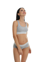 Fototapeta premium Beautiful young woman in grey sportive underwear isolated on white