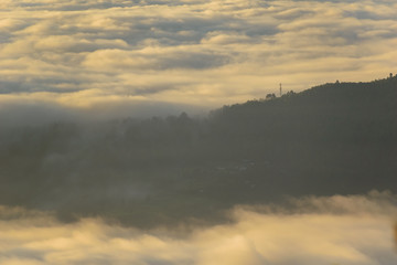 A beautifully scenic landscape of cloud rivers floating across the mountains around the Himalayan village of Chaukori in Uttarakhand, India.