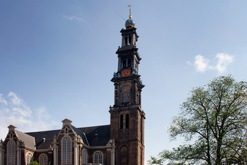 View of historical Westerkerk church in Amsterdam. 17th century structure with 85 meter tall spire. A crown-topped spire rises from this Renaissance-era Protestant church where Rembrandt is buried.