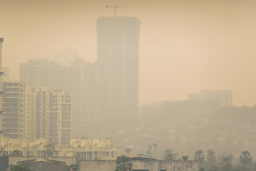 Fototapeta na wymiar High air pollution and haze envelops the high rises in the suburb of Kandivali East in Mumbai.