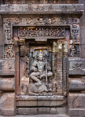 The exquisitely ornate details on a shrine of a Hindu God on the walls of the ancient Mukteshvara temple in the city of Bhubaneshwar in Orissa, India.