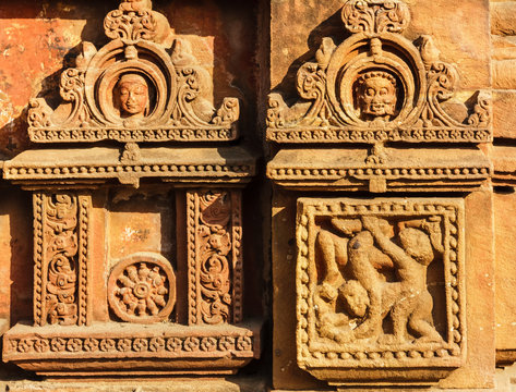 Beautiful, faded carvings on the walls of the ancient 10th century Mukteswara temple in the city of Bhubaneshwar in Orissa, India.