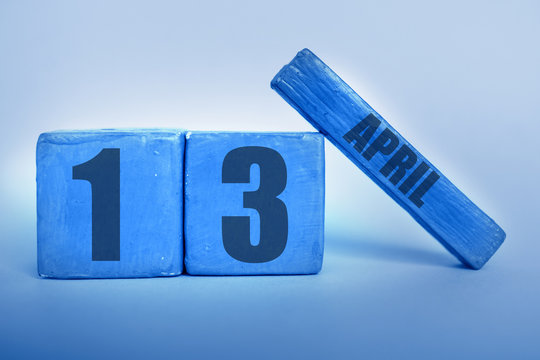 april 13th. Day 13 of month, Handmade wood cube calendar with date month and day in trendy classic blue color of the year spring month, day of the year concept