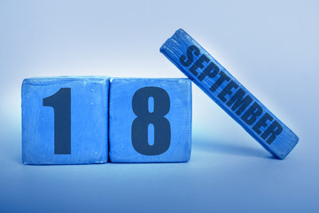 september 18th. Day 18 of month, Handmade wood cube calendar with date month and day in trendy classic blue color of the year autumn month, day of the year concept