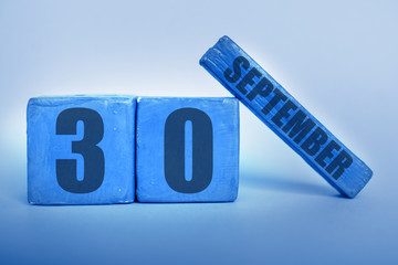 september 30th. Day 30 of month, Handmade wood cube calendar with date month and day in trendy classic blue color of the year autumn month, day of the year concept