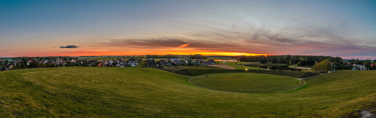 sunset over green field