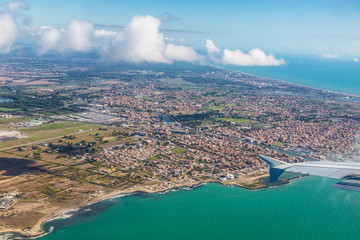 View from a flying plane on the city of Fiumicino and the Tyrrhenian sea, Italy