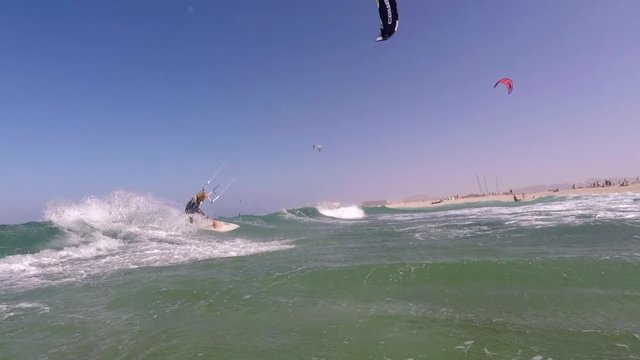 The kite surfer rides the waves of the Atlantic Ocean