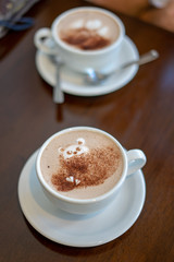 morning coffee. teddy bear latte art made with milk foam.cup of coffee on wooden table