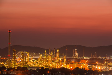 Fototapeta premium The colorful lights in oil refinery industry power station at night time with Twilight sky ,Chonburi,Thailand.