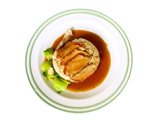 Top view roasted duck on steamed rice with Chinese sauce and boiled vegetables on white ceramic plate isolate on white background and make with paths.