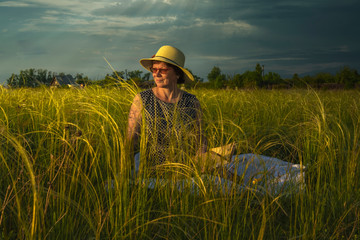 Girl in a field at sunset