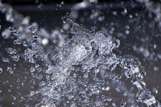 fountain close-up of water droplets dark background © Mokrousov Boris