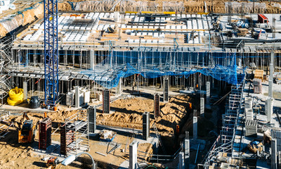 High perspective view of empty construction site with cranes