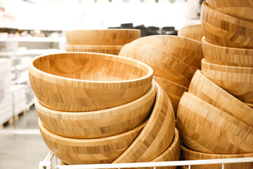 Bamboo wooden bowls for salads laying at the shop.