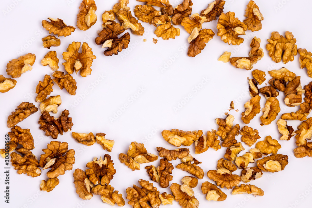 Wall mural Scattered peeled walnuts. Walnuts on a white background. - Wall murals