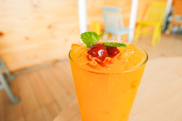 Fresh orange juice soda with strawberry syrup