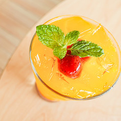 Fresh orange juice soda with strawberry syrup