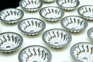 The detail of many moulds for Christmas cookies aligned on the table. 