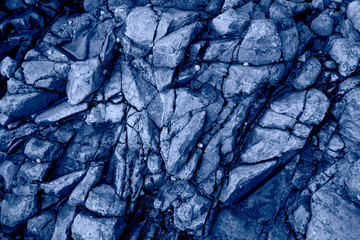 Closeup of natural stone pattern in France shore.Beautiful abstract texture in modern blue color.