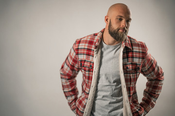 Fototapeta premium attractive man with beard and lumberjack shirt posing in studio photo on white background