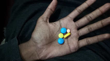 A person taking a medicine for his health to recover soon