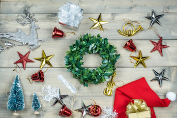 Christmas concept, Happy new year and celebrate holiday, copy space and top view with silver reindeer, shiny gold silver and red blink star, christmas wreath, santa claus hat and gift box.