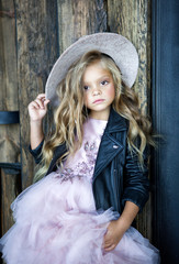 blonde girl in hat and leather jacket