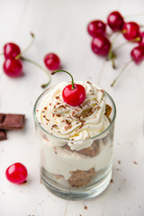 dessert with whipped cream, biscuit and cherry