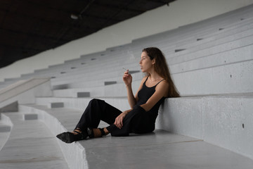 Beautiful girl smokes a cigarette. Looks like an addict. Location Estonia, Tallinn