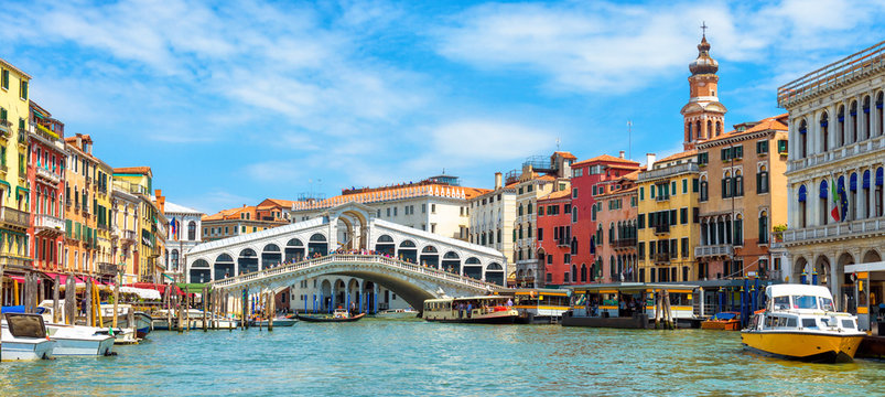 Panorama of Grand Canal, Venice, Italy. Rialto Bridge in the distance. It is famous landmark of Venice.