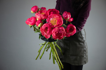 Beautiful bouquet of dark pink peony. The work of the florist. Flower delivery