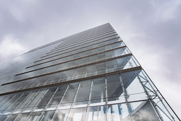 Dramatic view of skyscrapers against cloudy sky. View of the skyscraper from below